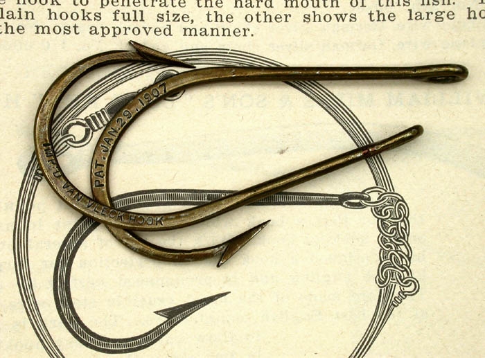 42b Two Van Vleck Improved Fish Hooks showing the embossed sides of the bends. One side says :Pat. Jan,29.1907” and the other “Imp’d Van Vleck Hook”.
