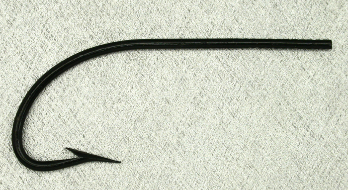Allcock, limerick, 5.0, japanned. These are two hooks I’m sure from the same box. I can’t say what the age of them is but when compared as two of these photos show, they differ significantly. The shanks are different length and the points are as well. It is either hand work or very sloppy machines. I am thinking the latter. Gift from Paul Rossman.