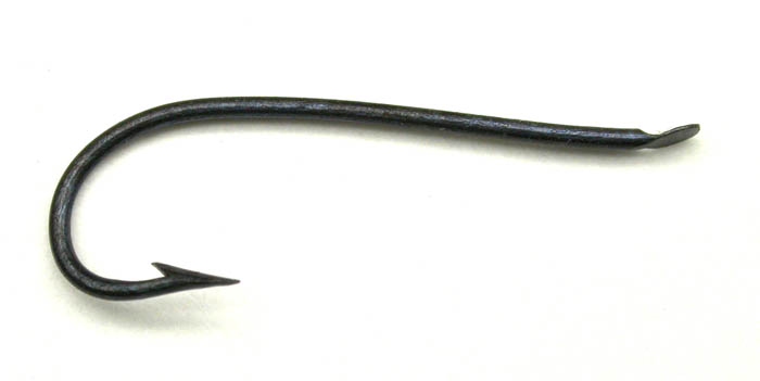 5b American Fish Hook & Needle Co., #8, Kirby bent, flatted, blued. About 11/16” long.