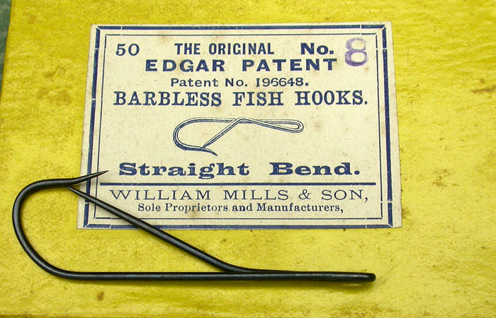 12. Edgar Patent Barbless Hooks, #8, straight bend, blued, patent No. 196648, made by William Mills & Son, sole proprietors and manufacturers. About 2 1/8” long. In the late 1800’s, discussions raged over the merits of “barbless” hooks. The arguments were focused generally on the point of fish hookup. In other words, the relative ease of penetration of a needle point hook sans barb vs. a more traditional barbed hook. Fish mortality also entered into the discussions but was a subordinate line of discussion. It seems the more things change, the more they stay the same as these discussions continue to this day. There was one fellow by the name of Butler Edgar who developed and patented the so called “Edgar Barbless Hook”. The idea was simple enough, have a needle point barbless hook for ease of hook up and another opposing needle point to prevent breaking off a fish. They were made by the Wm Mills & Son Company (The Bate hook company). Later, they were made and sold by other companies. Again, you can read more about this in Todd Larson’s book “The History Of The Fish Hook In America”.