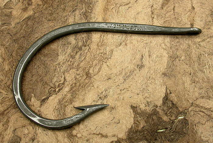 7a E Vom Hofe, Van Vleck hook, about 14/0, tinned, knife edge, needle eye, ca 1910. You can see how thick the plating was back in the day. On some hooks, the stuff just flakes off. On this hook, much of the lettering of the names has been filled in but enough remains to be able to read them. Modern plating technology lays down very thin layers with much better adhesion. Part of the 1900’s collection.